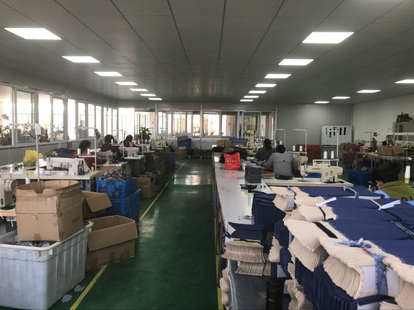 A clean and efficient factory floor with recycling bins