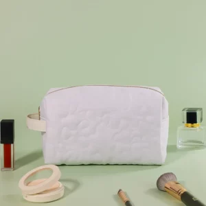 Eco-friendly cosmetic bags made from recycled cotton canvas, RPET, and organic fabrics, showcasing sustainable material options.