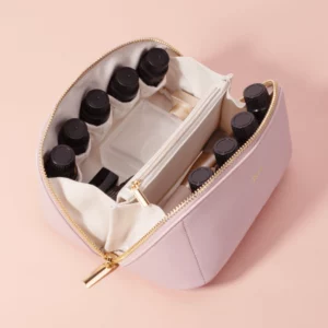 Pink makeup organizer bag with elastic bottle holders and central zipper compartment, designed for smart cosmetic storage.