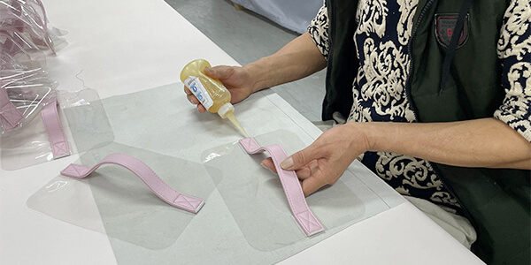 a factory production line efficiently manufacturing toiletry bags with TPU windows