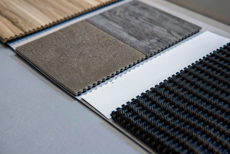 A display of different material swatches, one with a soft-touch texture, one with a dead-matte finish, and one with a high-gloss varnish.