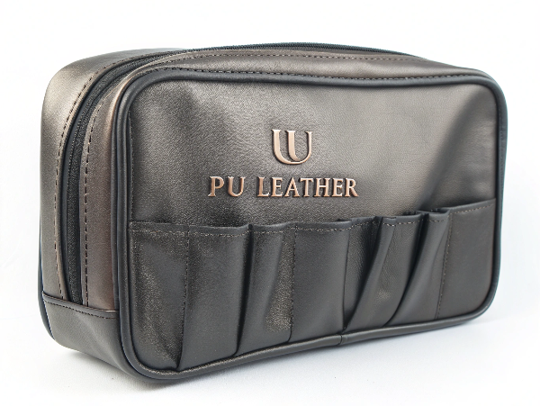 A sleek and sophisticated PU leather makeup bag with a debossed logo