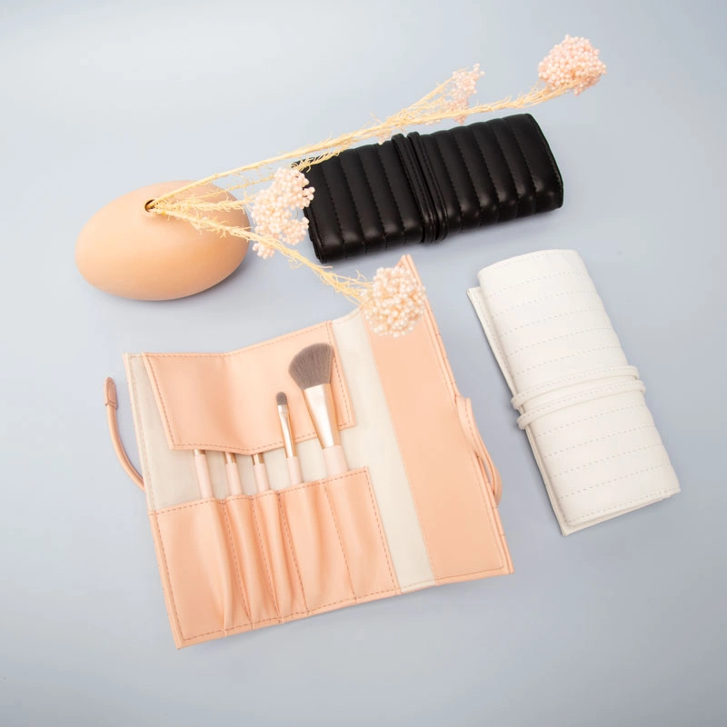 Recycled leather makeup brush rolls in black, white, and peach, displayed with brushes and soft decorative elements on a minimal background.