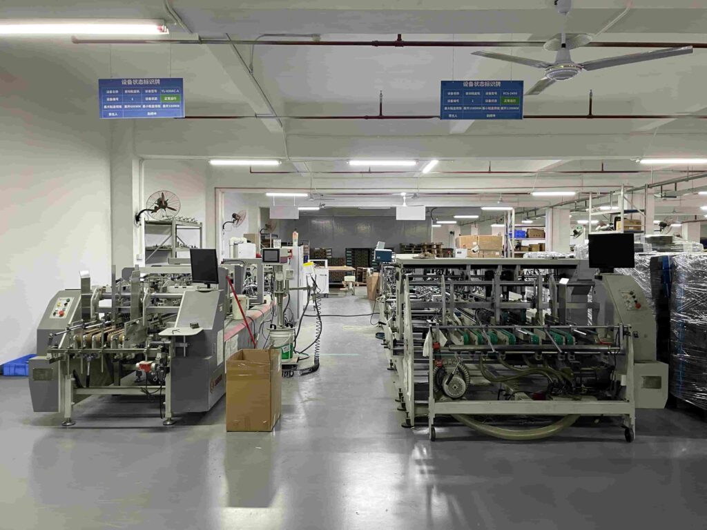 Automatic folding machine producing precision rigid paper boxes in a controlled manufacturing environment