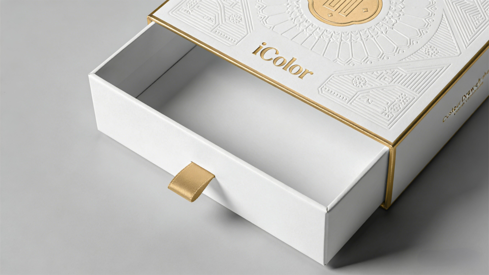 Debossing and gold foil detail on drawer box packaging