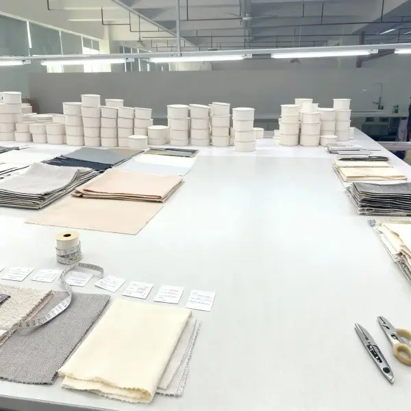Sample approval table with fabric swatches paper tube samples and measuring tools for custom packaging QC review